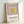 Framed poster displaying nested rectangular forms in cream and mauve with mustard accents, exemplifying meditative geometric abstraction in modernist style.