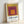 Abstract composition of centered squares in shifting warm tones—gold, burgundy, and orange—exemplifying the meditative geometric style of modernist color field art.