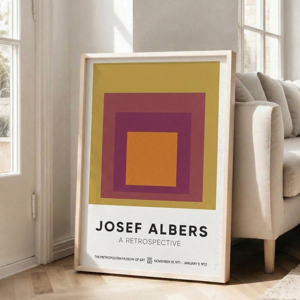 Stacked rectangular forms in burgundy, plum, gold, and orange create a balanced, meditative Bauhaus-inspired poster displayed on a wall.