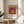 Minimalist arrangement of concentric squares in warm jewel tones including gold and burgundy, embodying the harmonious geometric principles of Bauhaus design as a framed wall print.