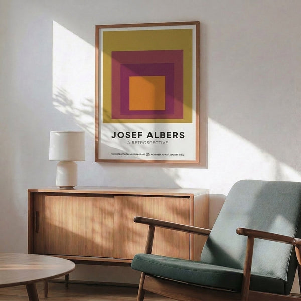 Nested squares in a warm palette of plum, orange, gold, and burgundy form a serene, geometric composition inspired by modernist color theory and displayed as framed wall art.
