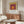 Bauhaus-style concentric rectangles in soft gold, deep burgundy, and plum create an optically harmonious, contemplative geometric poster for contemporary interiors.