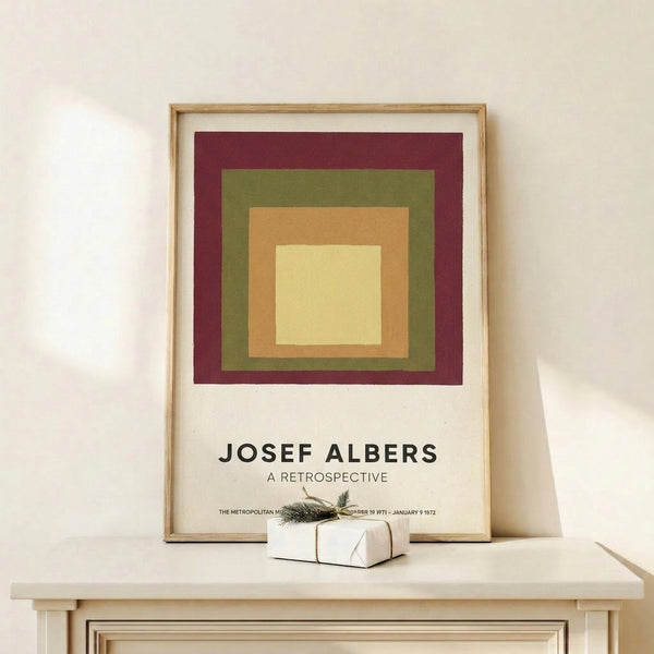 Bauhaus-inspired geometric poster displaying harmonious nested squares in cream, tan, and olive against a burgundy ground.