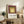 Mid-century modern framed poster with abstract squares in cream, pale yellow, olive green, and burgundy creating visual balance.