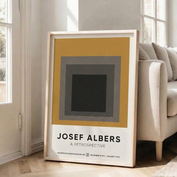 Contemporary framed poster with nested rectangular forms in warm gold, gray, and black hues, embodying the meditative essence of Bauhaus color theory.