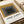 Modern wall poster featuring layered rectangular shapes in earthy mustard and gray tones with black accents, evoking meditative geometric minimalism and Bauhaus design philosophy.