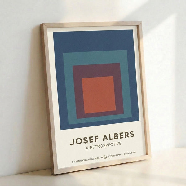 Framed Bauhaus poster displaying stacked squares in navy, burnt orange, and teal against a cream background, embodying geometric harmony and meditative design.