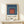Abstract art print with layered squares in cool and warm tones including teal, maroon, and cream, reflecting minimalist principles of color and form.