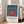 Museum-quality poster showcasing concentric rectangles in navy blue, burnt orange, and teal hues, evoking quiet geometric contemplation in Bauhaus tradition.