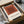 Abstract minimalist wall art displaying nested squares in burnt sienna and cream, embodying the sophisticated color theory of Bauhaus design.