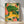 Whimsical boho poster featuring a playful lion cub surrounded by a colorful tropical menagerie including a parrot, monkey, and turtle nestled among lush green foliage and coral flowers in warm golden and teal tones.