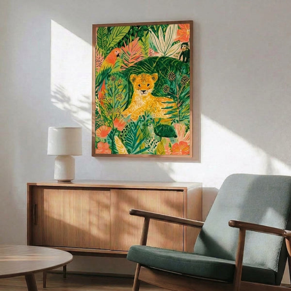 Cottagecore-style framed art print depicting a young lion cub with jungle companions including a colorful parrot and monkey, set among vibrant leaves and flowers in earthy, warm hues.