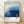 Minimalist Japandi landscape poster in layered blues and cream, featuring misty mountains and forest silhouettes in a meditative, modern art style.