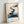 Wabi-sabi inspired watercolor poster featuring tranquil stepping stones leading across blue-teal water toward a minimalist landscape with soft neutral tones and meditative calm.