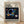 Abstract Bauhaus poster featuring overlapping circles and geometric shapes in dark blue, black, yellow, pink, and teal on a cream background, evoking a contemplative cosmic mood.
