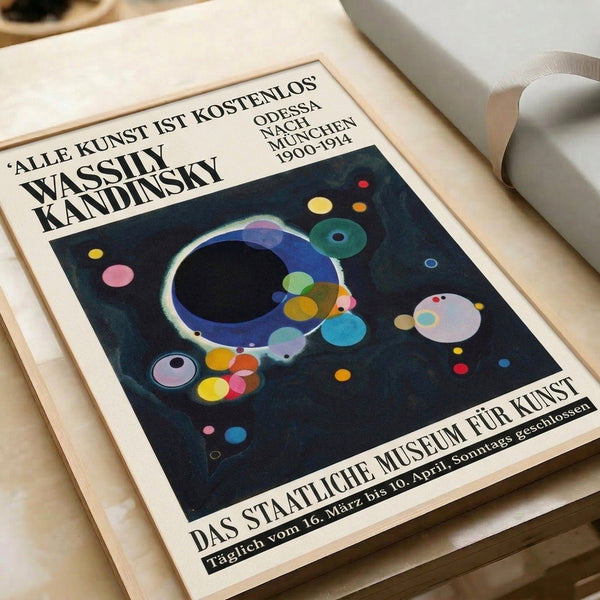 Geometric abstract wall poster presenting a meditative arrangement of circles and spheres in dark blue, black, gold, and pink against a cream field.