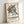 Mid-century modern abstract art print with energetic geometric elements in cream, purple, orange, and teal creating a contemplative yet dynamic composition.