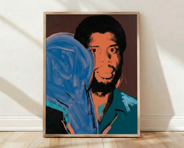 Pop art portrait of Kareem Abdul-Jabbar in vibrant, contrasting colors in the style of Andy Warhol, framed and displayed on a wall.