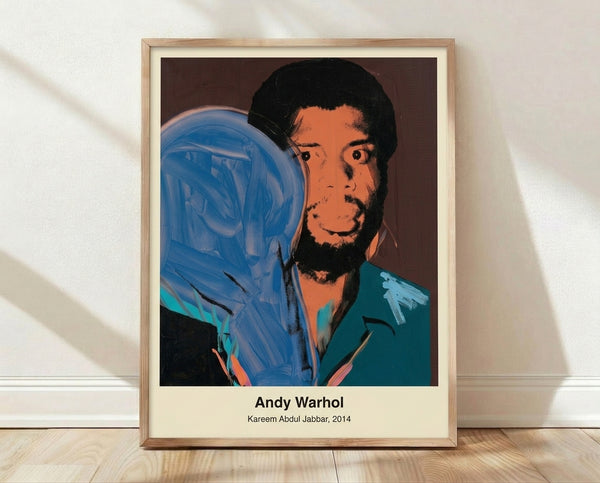 Bold pop art portrait of Kareem Abdul-Jabbar in vibrant yellow, hot pink, and electric blue with black outlines, celebrating the basketball legend in Warhol's iconic modern style.