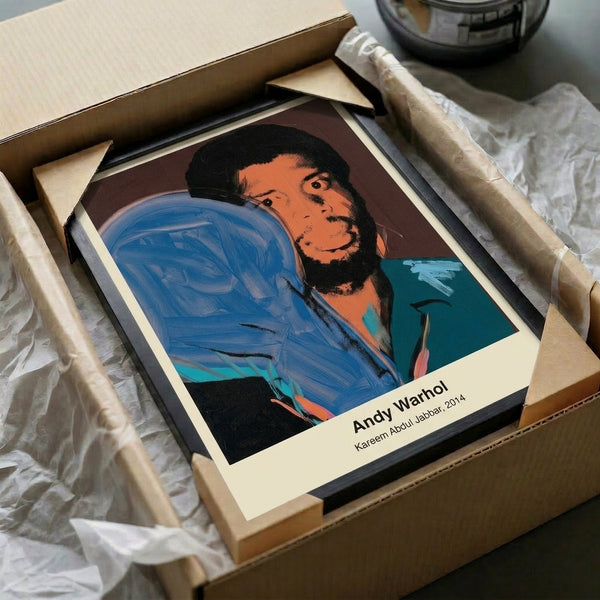 Pop art portrait celebrating basketball great Kareem Abdul-Jabbar in striking neon yellow, hot pink, and bright blue colors with strong black contours in the Warhol tradition.