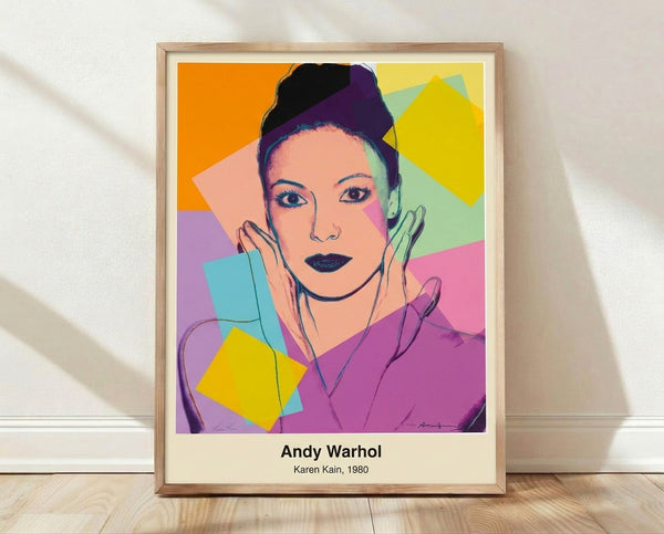 Pop art portrait of Karen Kain in vibrant cyan, magenta, and yellow tones with bold black outlines, framed poster on wall.