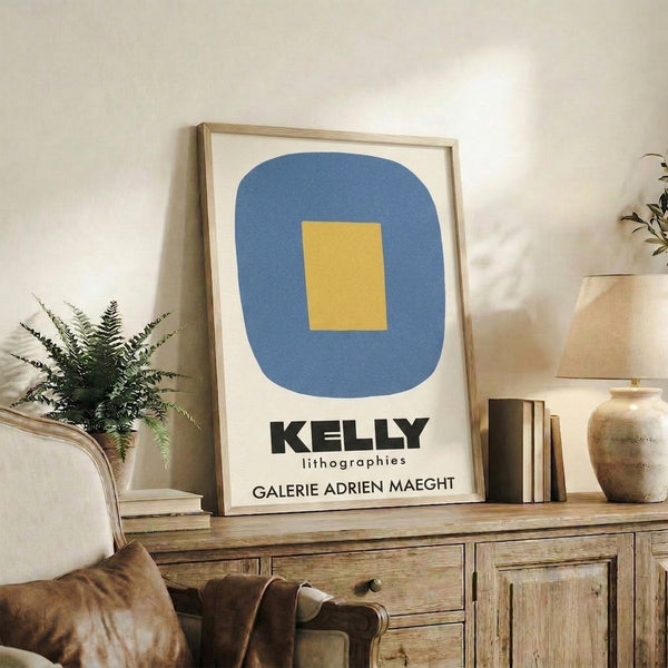 Wall-mounted framed print showcasing Bauhaus-inspired geometric abstraction in cool slate blue, warm golden yellow, and neutral cream palette.