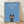 Minimalist framed poster of a black cat against a soft sky blue background with cream accents, inspired by Studio Ghibli's whimsical aesthetic.