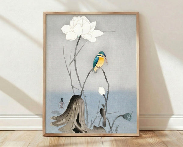 Framed Japanese woodblock-style art print featuring a serene kingfisher perched near white lotus flowers and graceful branches in cream, teal-blue, and soft gray tones.