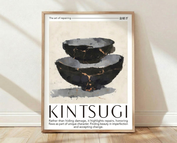 Minimalist framed poster featuring a cream ceramic bowl with charcoal and gold kintsugi repair lines, embodying wabi-sabi philosophy and the beauty of imperfection.