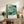 Minimalist Asian-inspired wall art depicting abstract lotus leaves in soft sage and teal with golden kintsugi-style accents, creating a serene focal point.