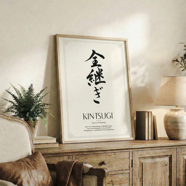 Understated framed poster combining minimalist brushwork and Japanese script in black and taupe hues on cream, celebrating the art of mindful repair and acceptance.