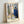Melancholic poster artwork of a couple sharing a kiss framed against a windowpane, painted in cool blues and warm earth tones with an introspective, tender atmosphere.