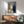 Expressionist-style framed artwork depicting an intimate kiss by a window, dominated by soft earth tones and creating a contemplative, peaceful mood.