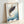 Serene Japanese-inspired framed poster showing a graceful koi fish in contemplative motion, featuring soft blues, golds, and cream hues.