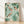 Serene Japanese ink painting of koi swimming among aquatic plants in sage green and cream tones, framed as a minimalist wall art print with zen aesthetic.