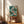 Framed wall art showcasing graceful koi among blooming lotus flowers in a Japanese woodblock style, combining cream, coral red, and dark teal in a peaceful composition.