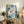 Framed Japandi art print showing graceful koi fish beneath aquatic plants in a contemplative water scene with slate blue and cream accents.