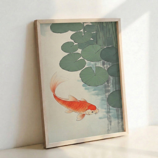 Framed zen wall art depicting graceful koi in water with floating lily pads, executed in soft blue-gray and sage green with coral accents in a minimalist Japanese style.