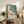 Minimalist Japanese-inspired framed artwork of koi fish swimming beneath lily pads, evoking tranquility through soft sage green, coral red, and cream tones.