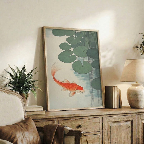 Minimalist Japanese-inspired framed artwork of koi fish swimming beneath lily pads, evoking tranquility through soft sage green, coral red, and cream tones.