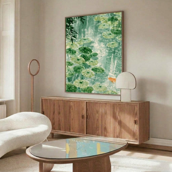 Framed watercolor painting of a tranquil pond scene with koi fish, lily pads, and gentle ripples in cream, mint, and dark green hues, capturing a peaceful Japandi garden mood.