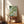 Japandi wall art featuring koi fish gliding through a meditative rainscape with floating lily pads and bamboo, done in soft blue and sage green woodblock style.