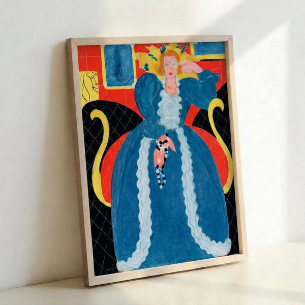 Framed modern art print showing a poised woman in flowing blue garments, surrounded by ornamental patterns in warm hues, capturing the essence of early 20th-century French modernism.