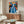 Matisse poster displaying a reclining or seated woman in rich blue hues against a warmly colored, decoratively patterned interior setting rendered in bold simplified forms.