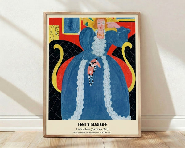 Framed Matisse-style poster of a contemplative woman in blue sitting by an open door overlooking a Mediterranean coast, with tropical palm trees and warm terracotta tones in a modern art nouveau composition.