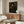 Impressionistic framed portrait of a bearded gentleman in earthy browns and shadowed blacks, conveying dignified contemplation through warm, expressive brushwork.
