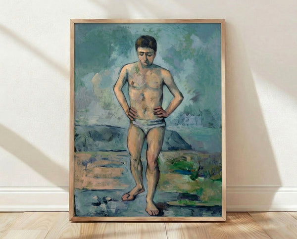 Framed poster of Le Grand Baigneur, a classical figure painting in warm earth tones and soft watercolor style, displayed on a wall.