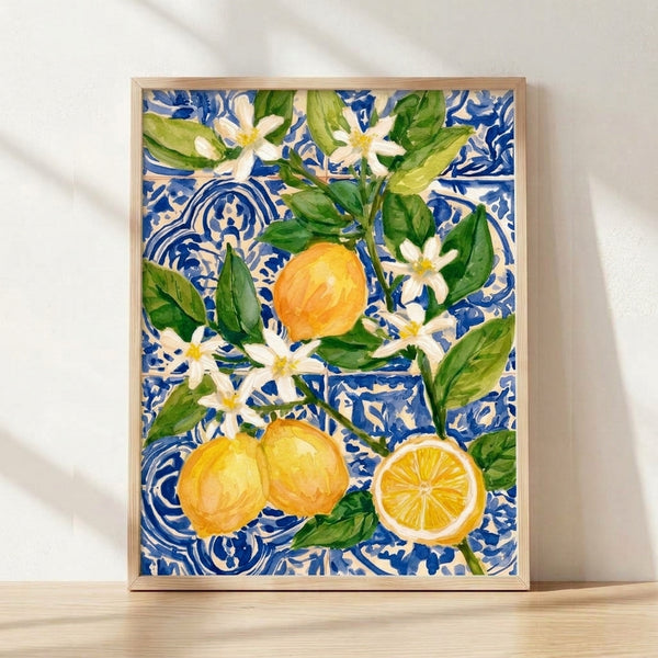 Watercolor botanical art print featuring vibrant yellow lemons and delicate blossoms with green leaves on a rich cobalt blue background, framed on a wall in a fresh, elegant boho style.