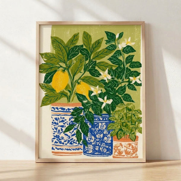 Framed retro Japandi poster of a potted lemon tree with golden yellow fruit and olive green leaves in a cobalt blue pot, set against a cream background in a cheerful, minimalist style.
