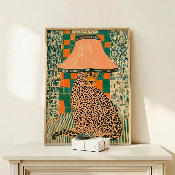 Playful, surreal framed art print showing a spotted leopard in a hide-and-seek pose next to a retro lamp, with vibrant orange, teal, and cream tones against black outlines.